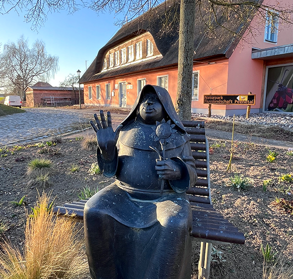 Naturpark Flusslandschaft Peenetal mit Statue auf der Bank